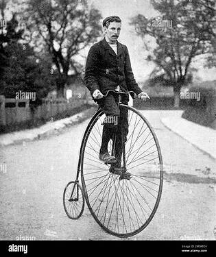penny-farthing-or-ordinary-bicycle-of-the-1870s-with-its-rider-wearing-contemporary-cycling-clothes-2M3K0C4-1903272907